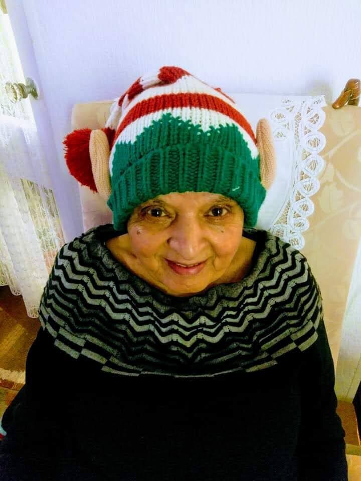 Surjit beaming in a festive knitted elf hat with a mischievous smile
