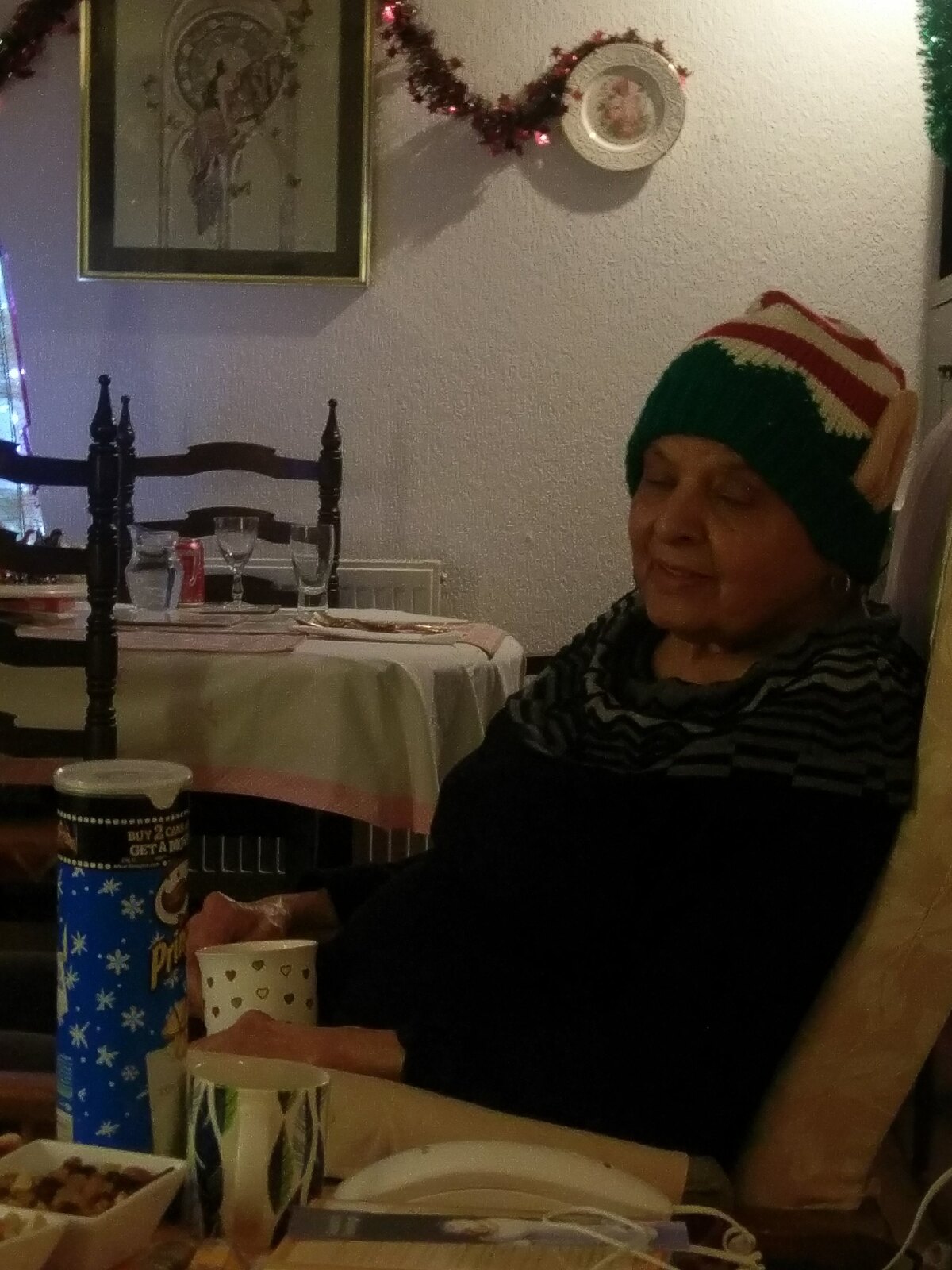 Surjit enjoying Christmas dinner in her favourite knitted hat