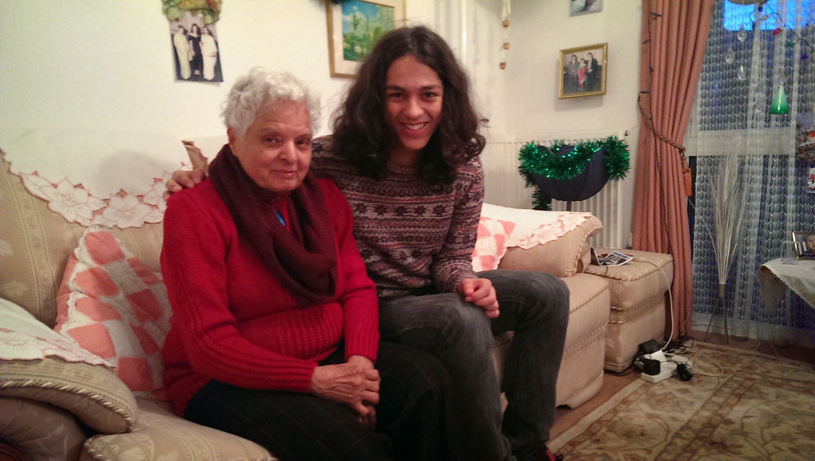 Surjit and grandchild sitting together on the sofa
