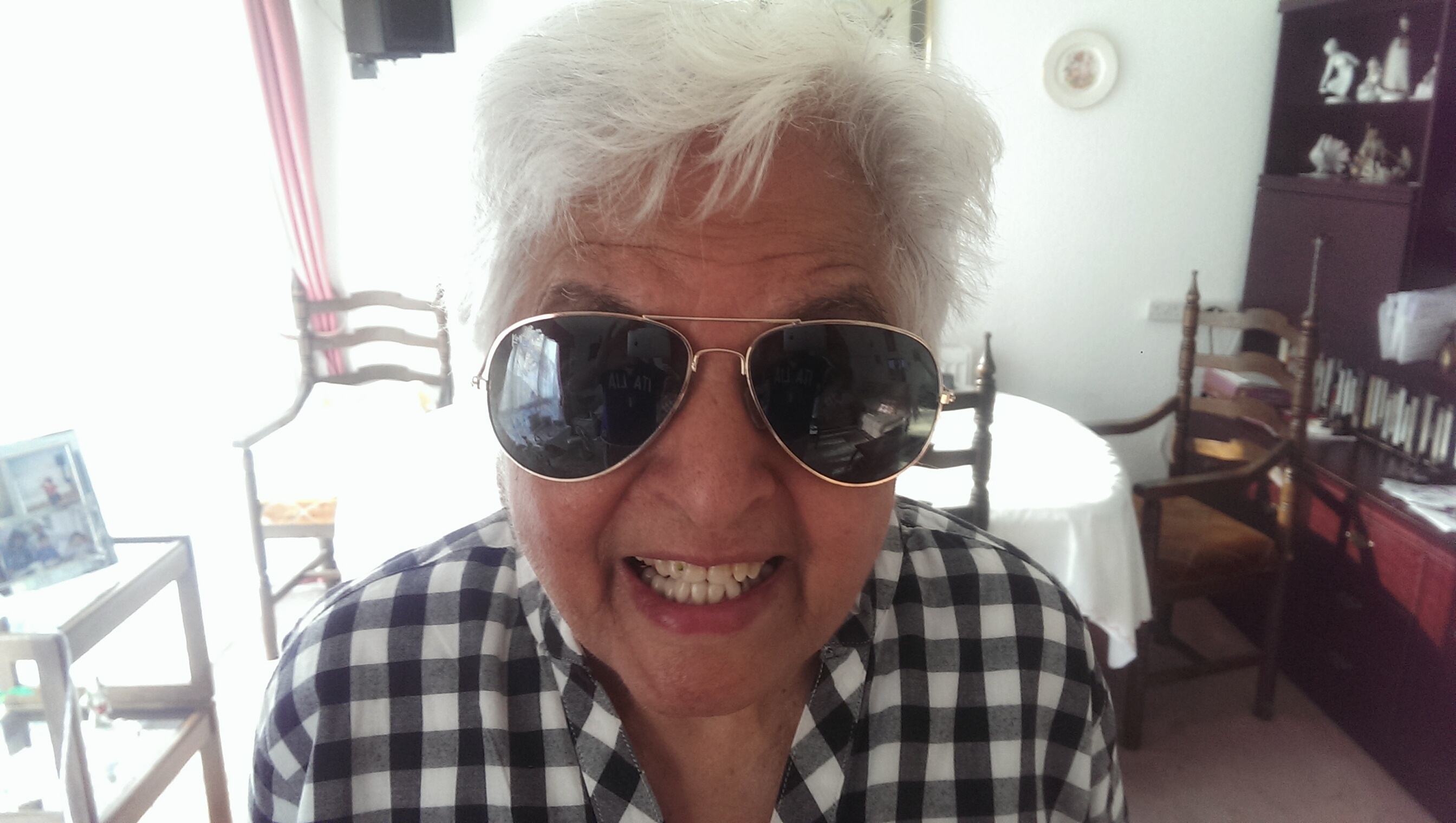Surjit being playful, wearing a pair of sunglasses