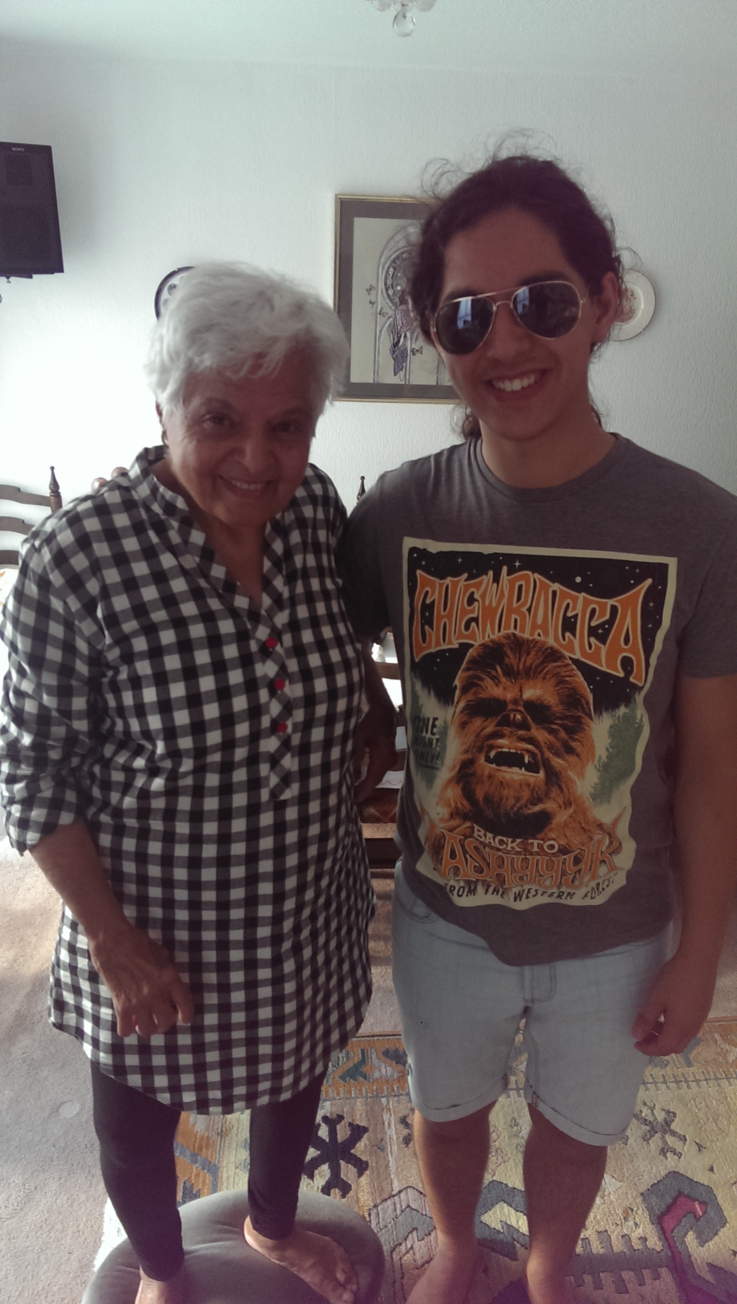 Surjit standing proudly beside her grandson