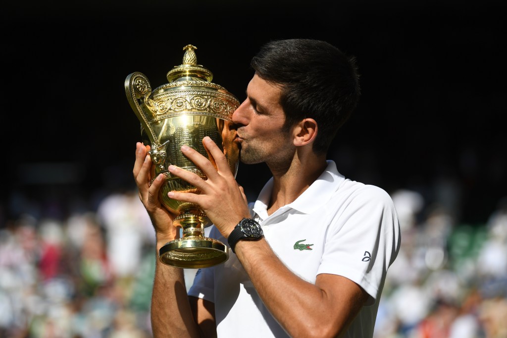 Novak Djokovic kissing the Wimbledon trophy in 2018