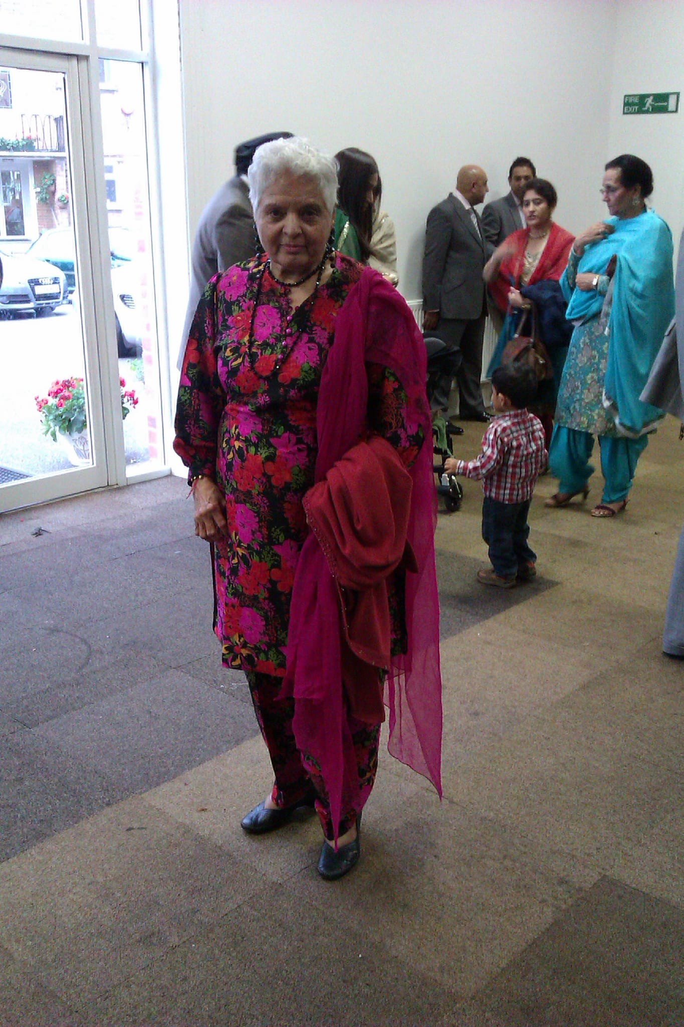 Surjit looking elegant in a striking outfit at a gathering