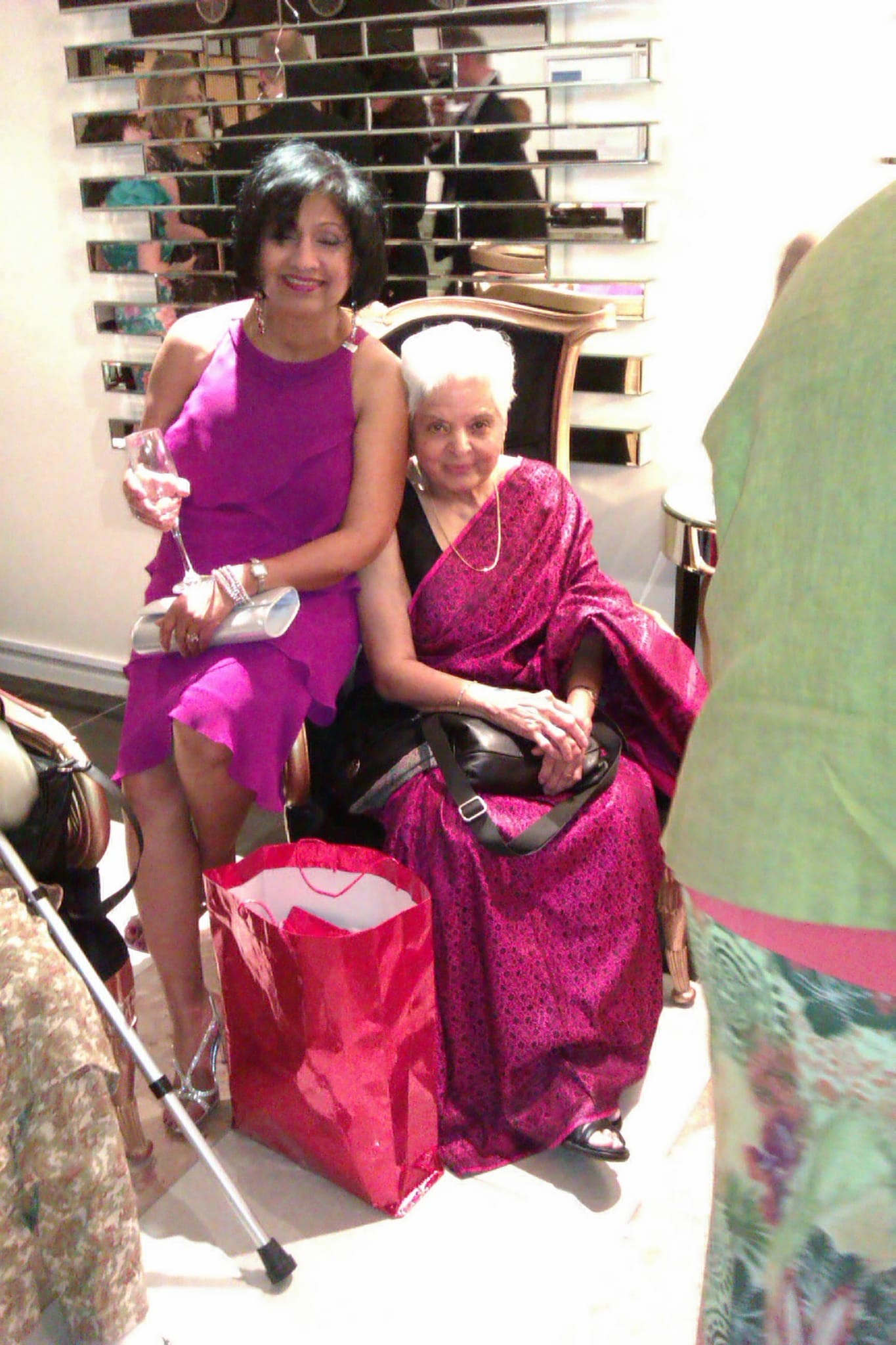 Surjit seated beside a loved one at a special celebration