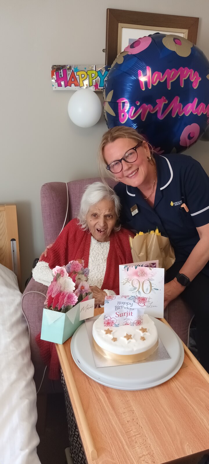 Surjit celebrating her 90th birthday with a cake, flowers and cards — a wonderful milestone