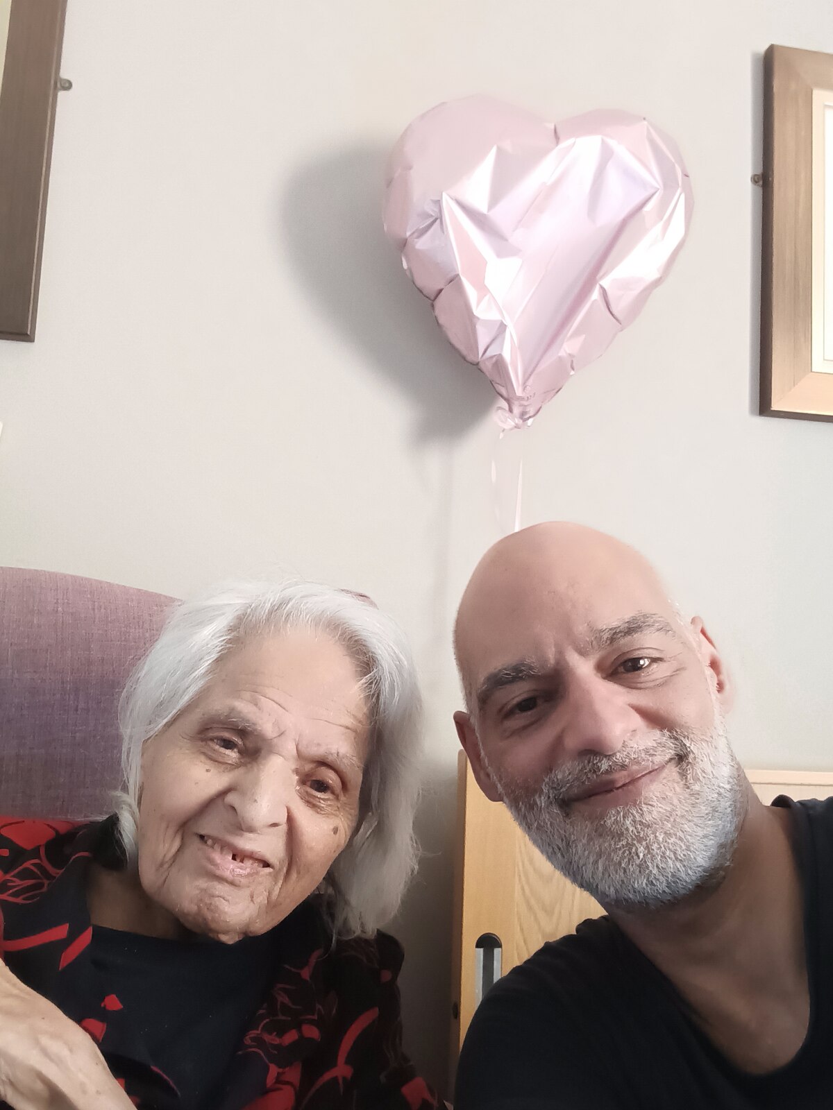 Surjit with her son and a pink heart balloon — a special day