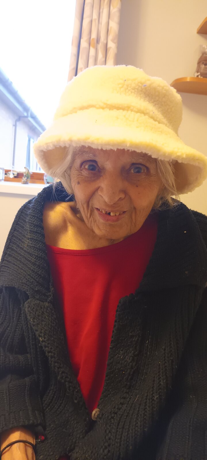 Surjit beaming in a sunny yellow hat