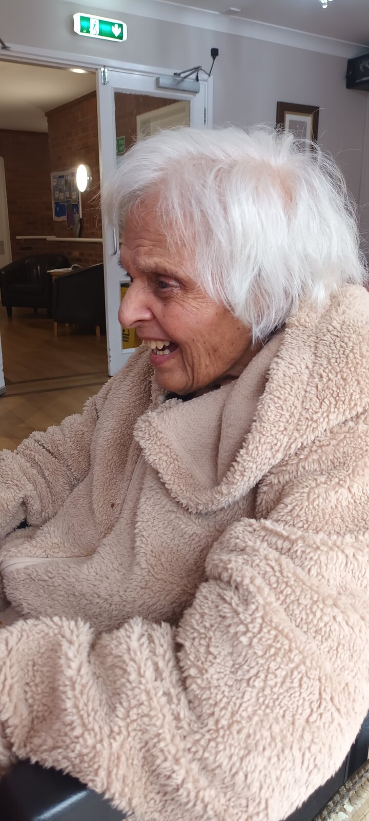 Surjit wrapped in a cosy fleece with her warm, signature smile