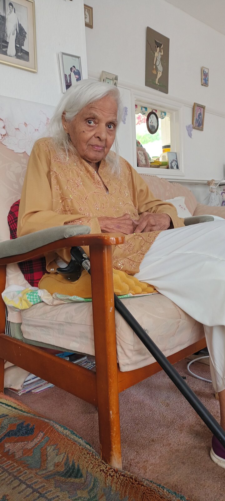 Surjit looking regal in a golden embroidered kameez at home